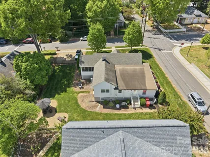 an aerial view of a house with swimming pool and garden