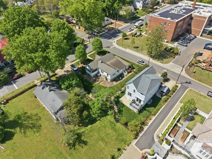 an aerial view of a residential houses with outdoor space