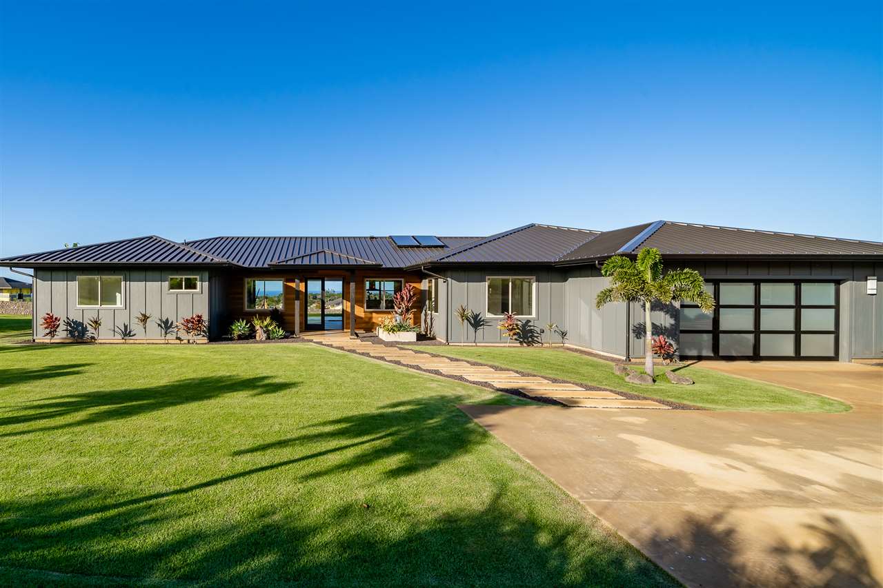 a front view of a house with a yard table and chairs