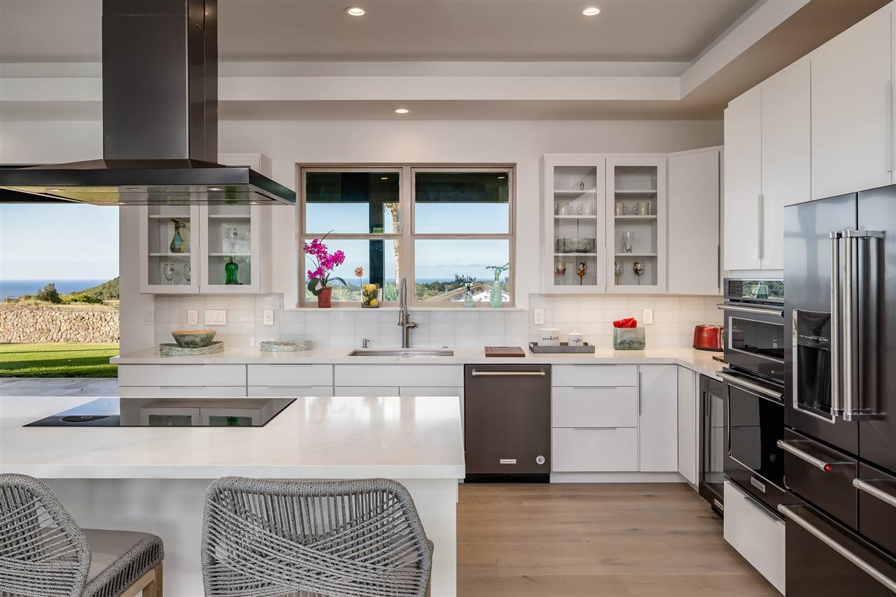940 Auwaha Street, Unit A Haiku, HI 96708 - Photo 11 of 28 a kitchen with granite countertop a sink stainless steel appliances and cabinets