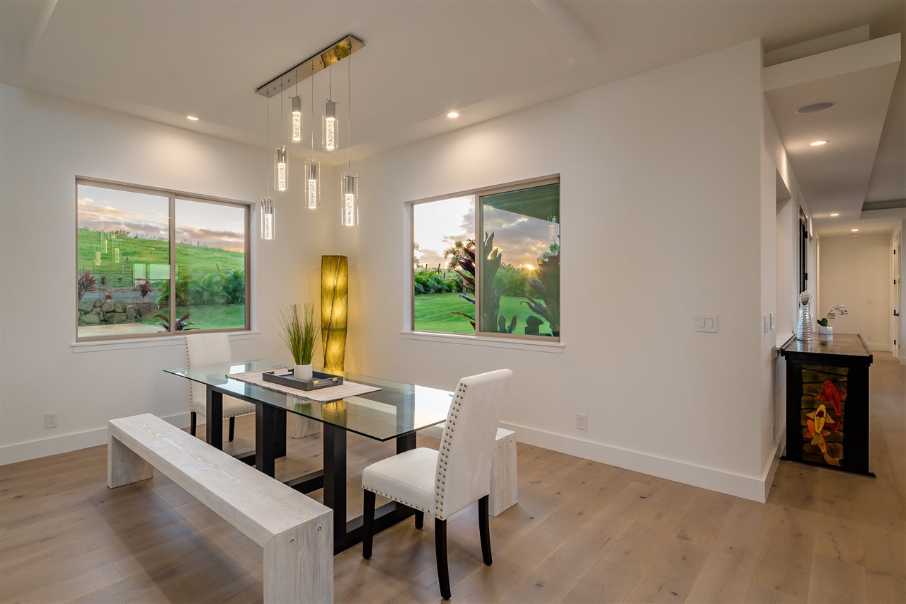 940 Auwaha Street, Unit A Haiku, HI 96708 - Photo 13 of 28 a view of a dining room with furniture a chandelier and wooden floor