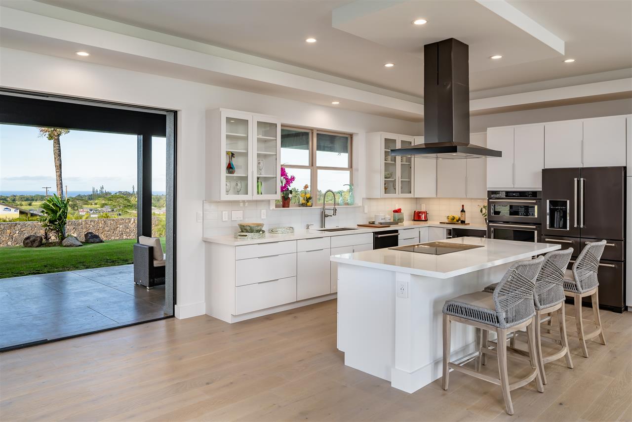 940 Auwaha Street, Unit A Haiku, HI 96708 - Photo 9 of 28 a kitchen with a sink stainless steel appliances and white cabinets