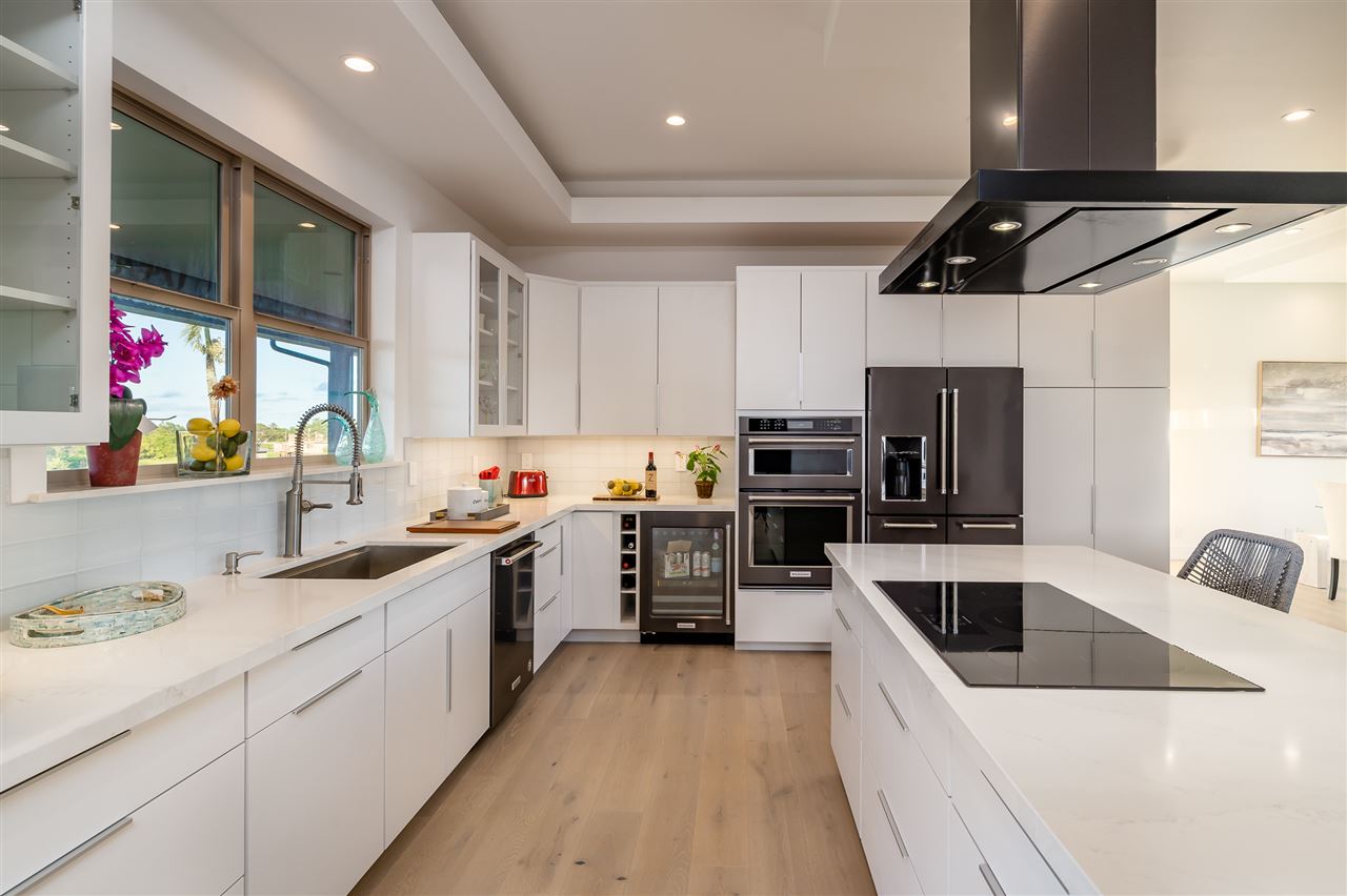 940 Auwaha Street, Unit A Haiku, HI 96708 - Photo 10 of 28 a kitchen with a sink a counter top space stainless steel appliances and cabinets
