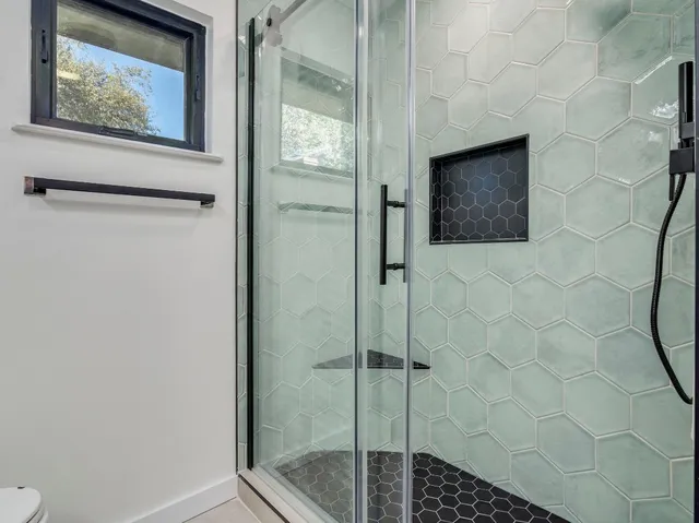 a bathroom with a shower and a sink