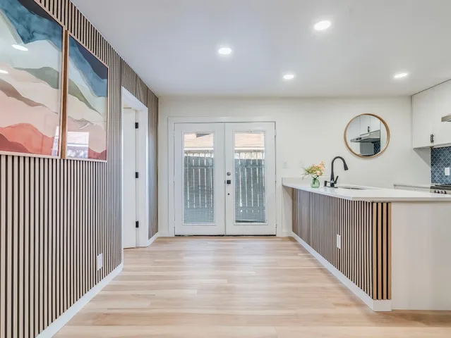 a view of a hallway with wooden floor