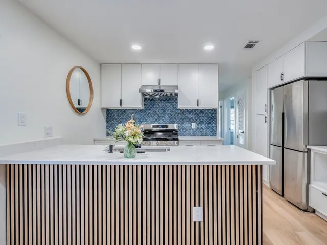 a kitchen with a refrigerator and a stove