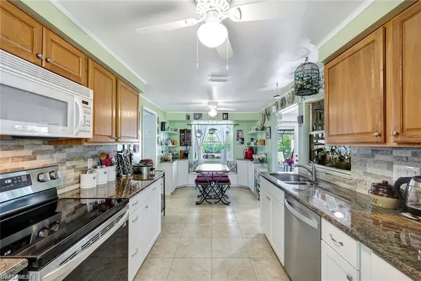 a open kitchen with stainless steel appliances granite countertop a stove and cabinets