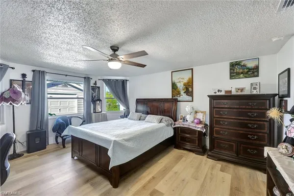 a living room with a bed next to a window
