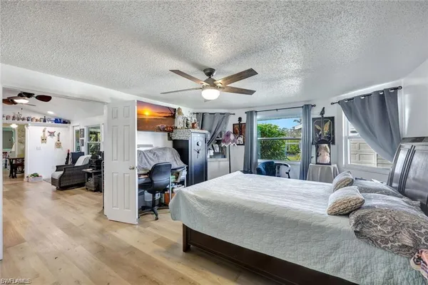 a bedroom with a large bed and a large window with the outer view