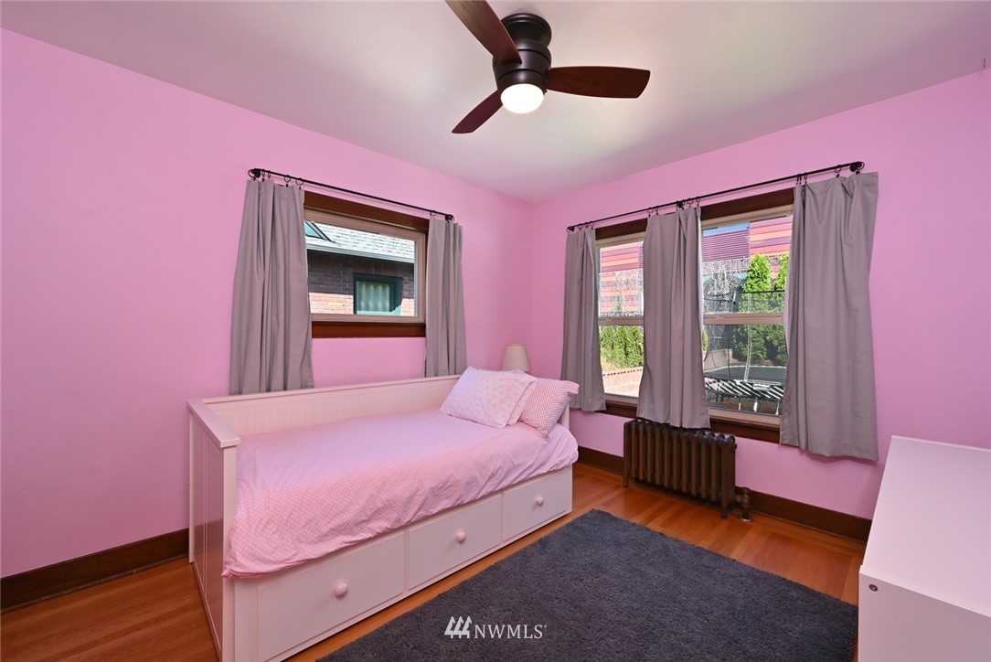 1142 North 78th Street Seattle, WA 98103 - Photo 14 of 24 a bedroom with a bed dresser and a window