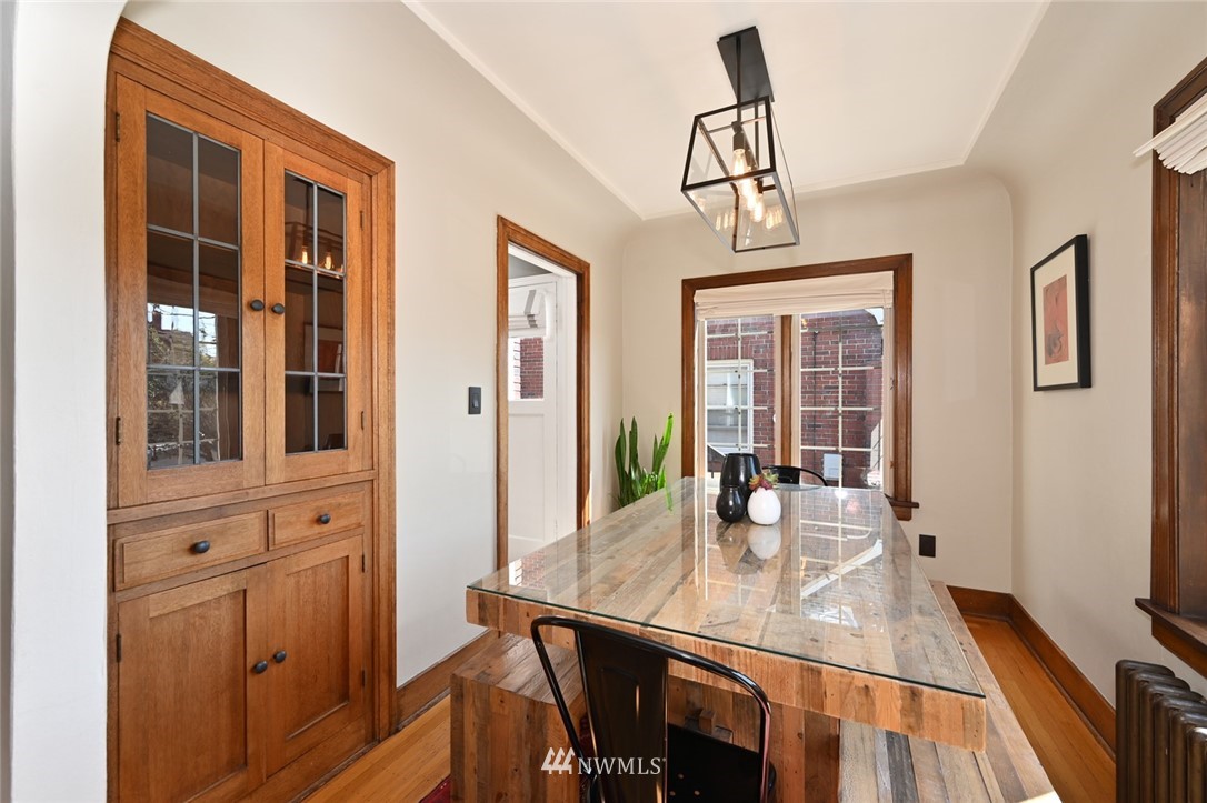 1142 North 78th Street Seattle, WA 98103 - Photo 8 of 24 a view of a dining room with furniture window and wooden floor