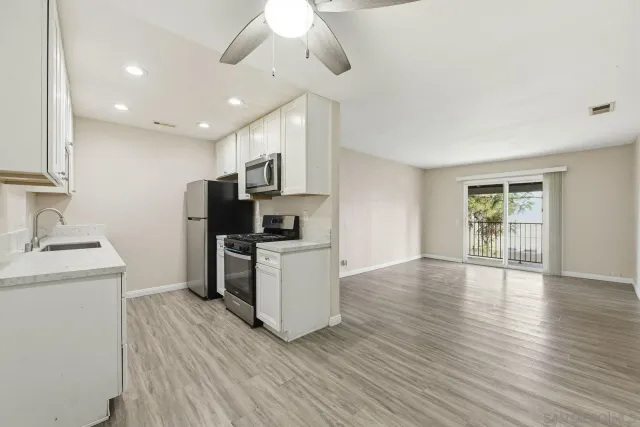 a kitchen with a refrigerator and a stove top oven