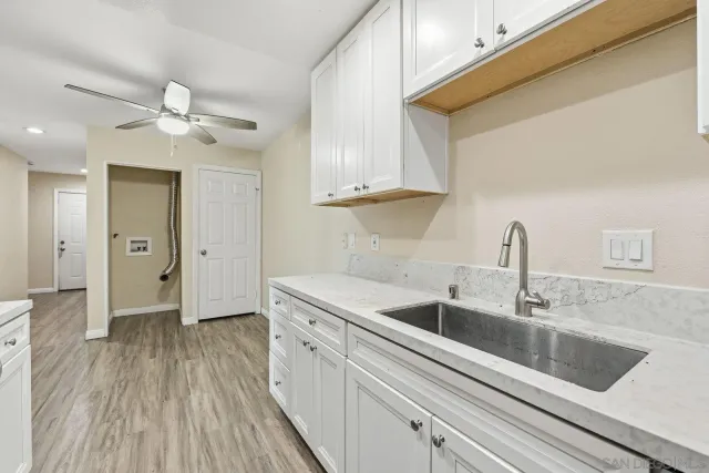 a kitchen with a sink and cabinets