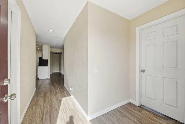 a view of a hallway with wooden floor