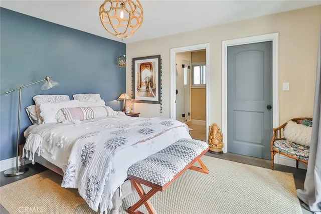 a bedroom with a bed and a chandelier