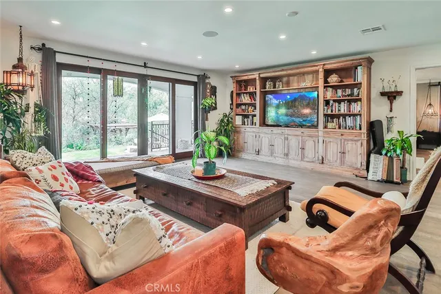 a living room with furniture and large window