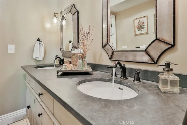 a bathroom with a double vanity sink and a mirror