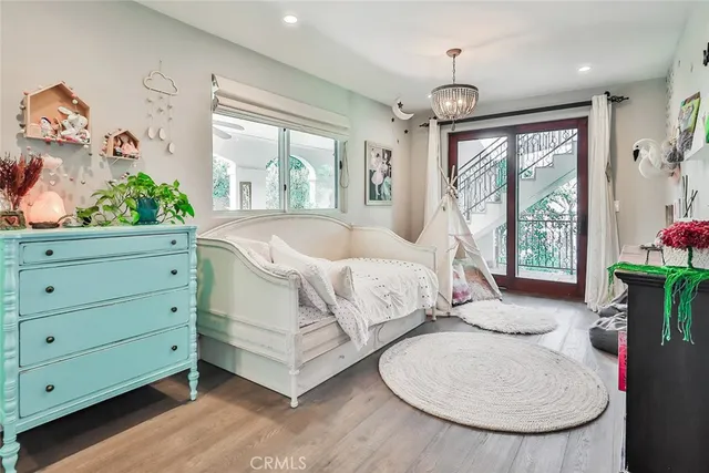 a bed sitting in a spacious bedroom next to a window