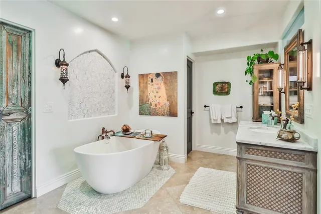 a bathroom with a bathtub shower sink and mirror