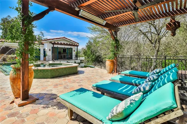 a view of a patio with chairs and a fire pit