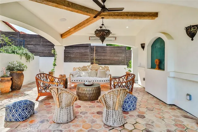 a view of a patio with table and chairs and potted plants