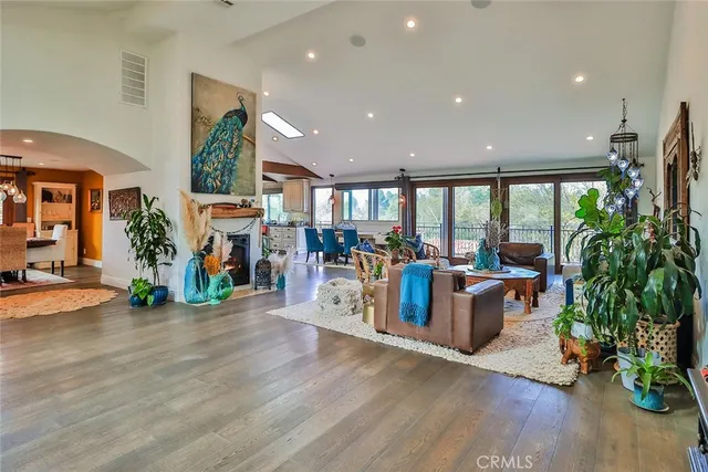 a living room with furniture a wooden floor and a large window