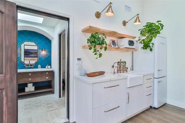 a room with painting and potted plant