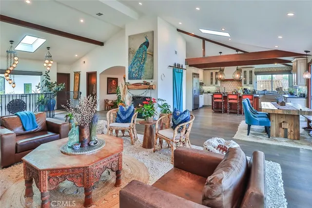 a living room with fireplace furniture and a large window
