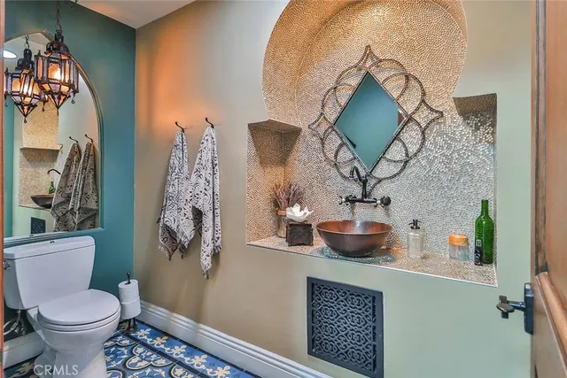 a bathroom with a toilet sink and mirror