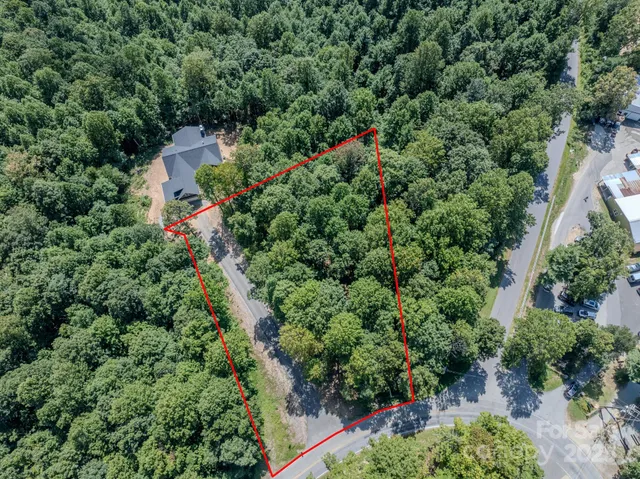 an aerial view of a house with a yard and outdoor seating