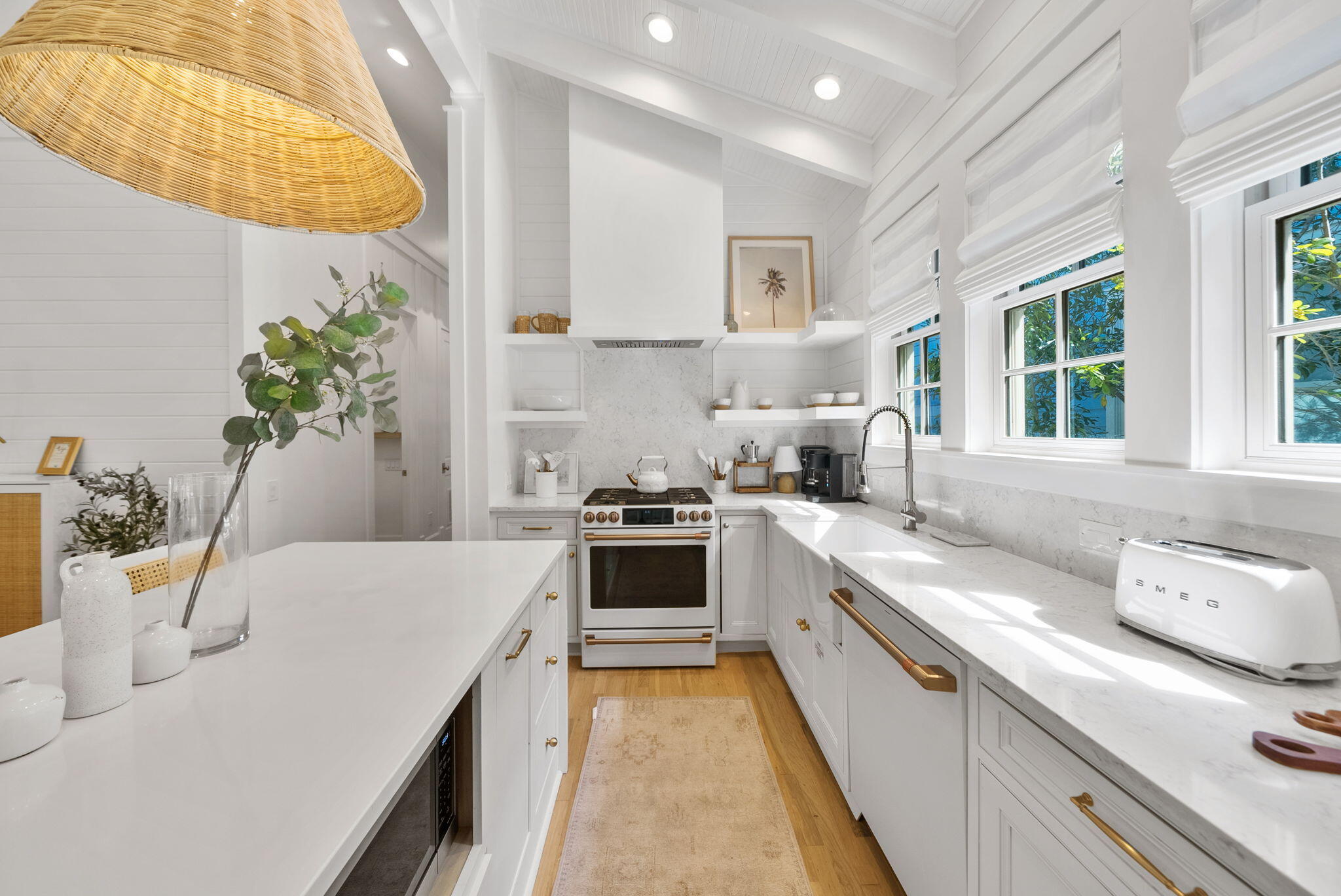 133 Silver Laurel Way Santa Rosa Beach, FL 32459 - Photo 11 of 42 a large white kitchen with stainless steel appliances granite countertop a stove a sink and a white wooden cabinets