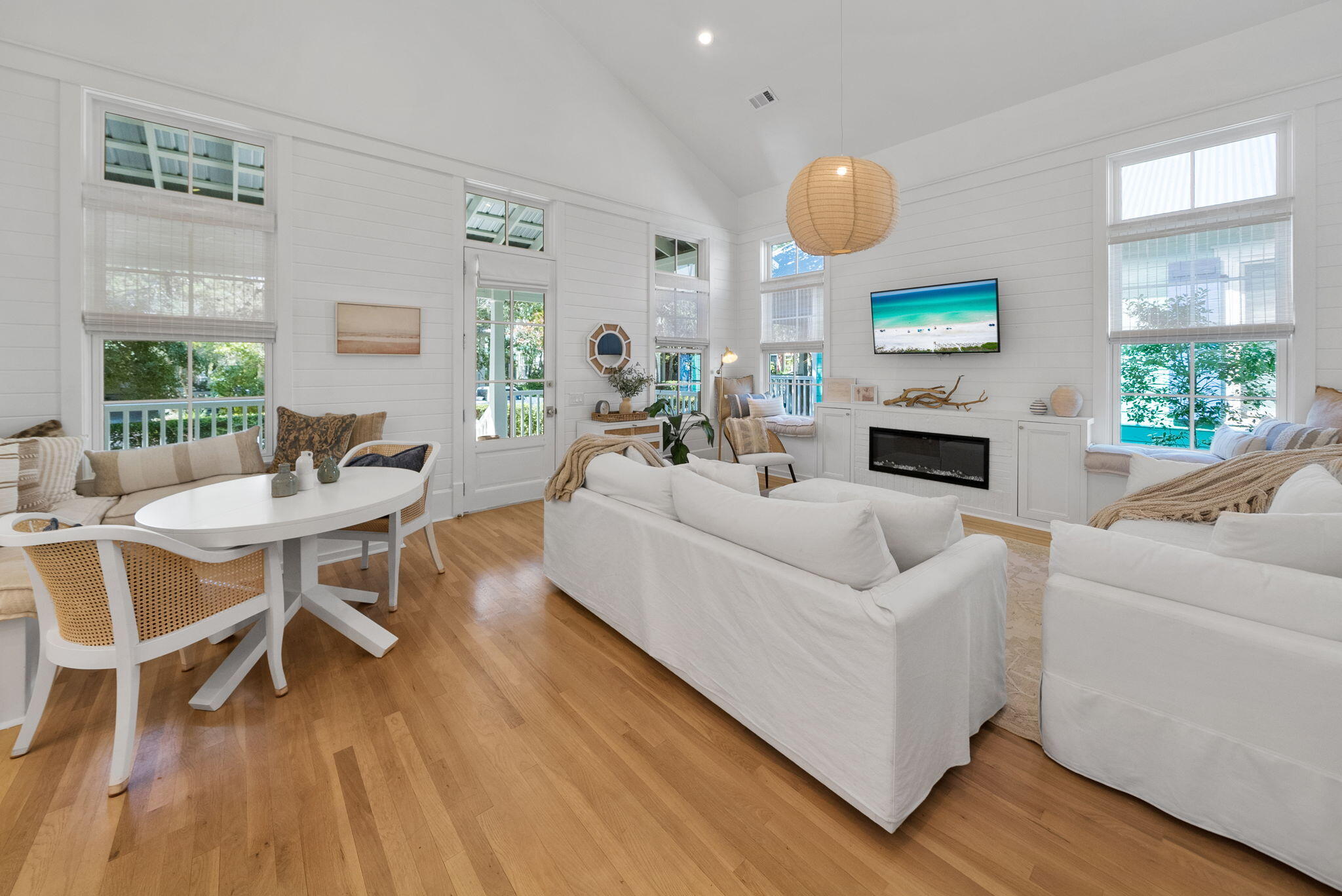 133 Silver Laurel Way Santa Rosa Beach, FL 32459 - Photo 6 of 42 a living room with furniture dining table and a fireplace