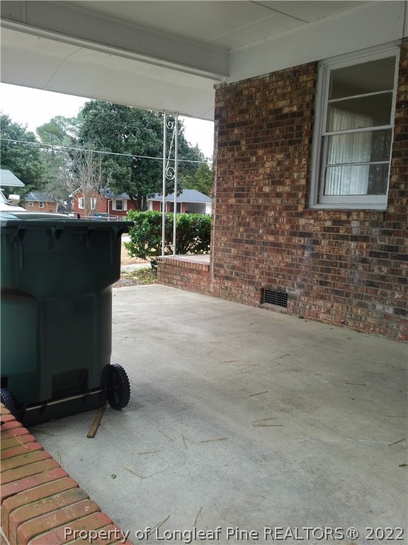 a view of a porch with a floor to ceiling window