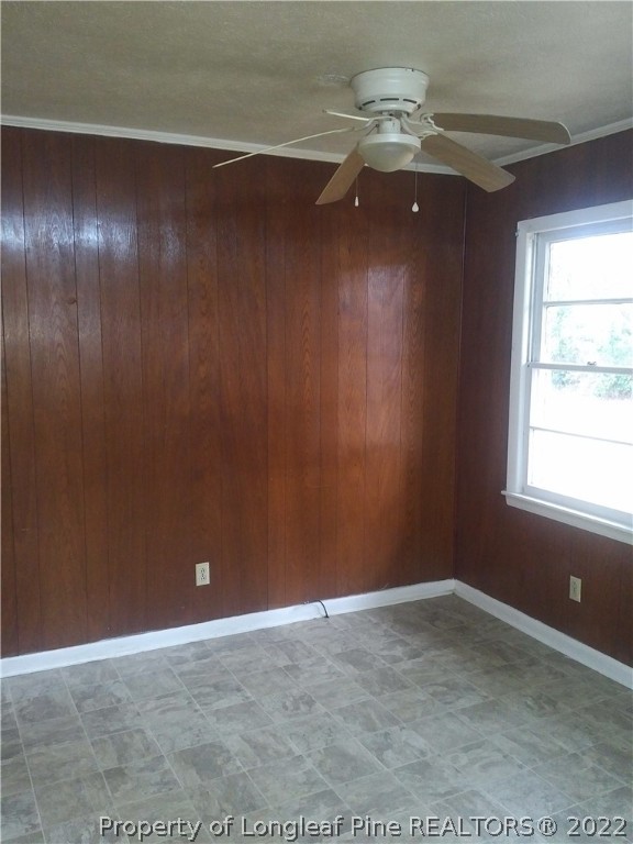 5025 Houston Road Fayetteville, NC 28311 - Photo 3 of 11 a view of an empty room with chandelier fan and wooden floor