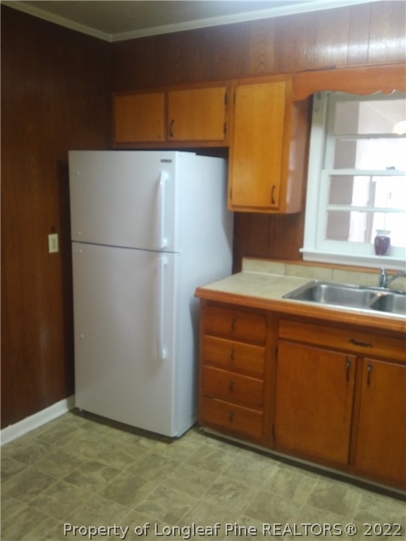 5025 Houston Road Fayetteville, NC 28311 - Photo 4 of 11 a view of a kitchen with a sink and a refrigerator