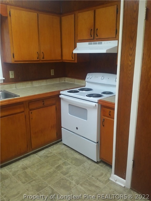 5025 Houston Road Fayetteville, NC 28311 - Photo 5 of 11 a kitchen with a sink stove and cabinets
