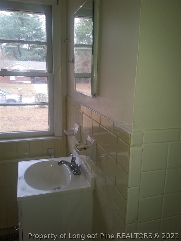 5025 Houston Road Fayetteville, NC 28311 - Photo 9 of 11 a bathroom with a sink a window and a bathtub