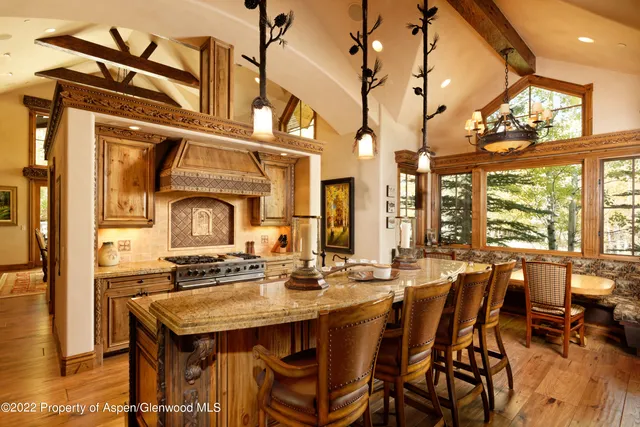 a living room with lots of furniture and a large window