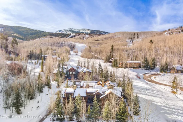 a view of a house with a snow yard and a yard