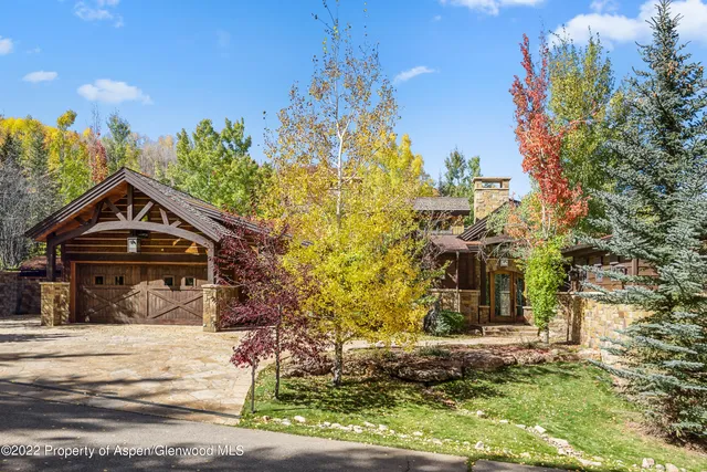 a living room with patio furniture and a large window