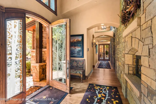 a living room with furniture and large windows