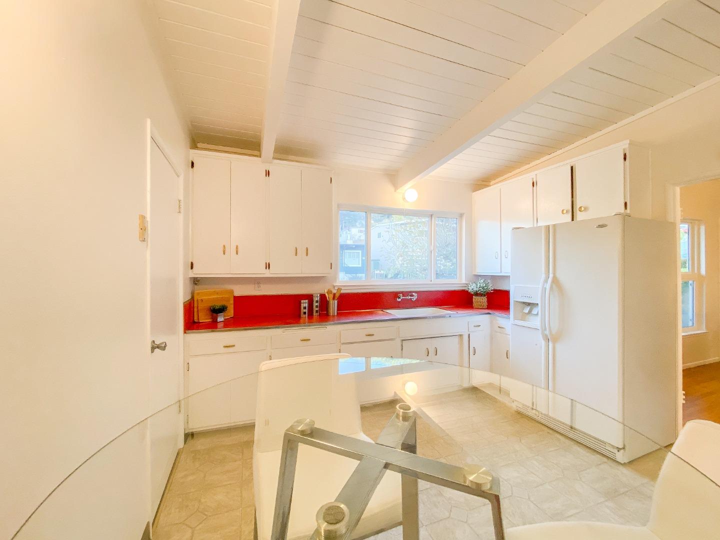 266 Hillside Drive Pacifica, CA 94044 - Photo 19 of 37 a room that has a bed and a stove in it