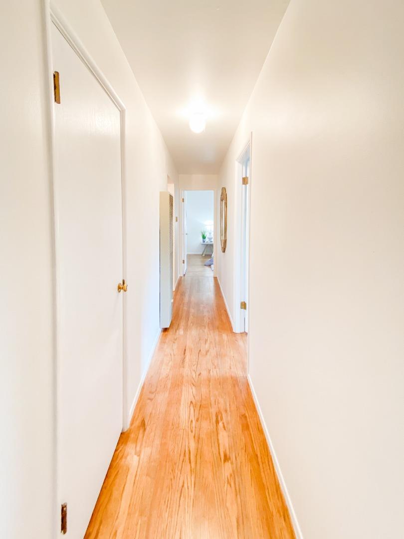 266 Hillside Drive Pacifica, CA 94044 - Photo 23 of 37 a view of a hallway with wooden floor