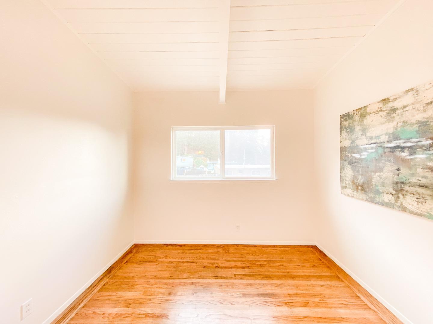 266 Hillside Drive Pacifica, CA 94044 - Photo 25 of 37 a view of a room with wooden floor and a window