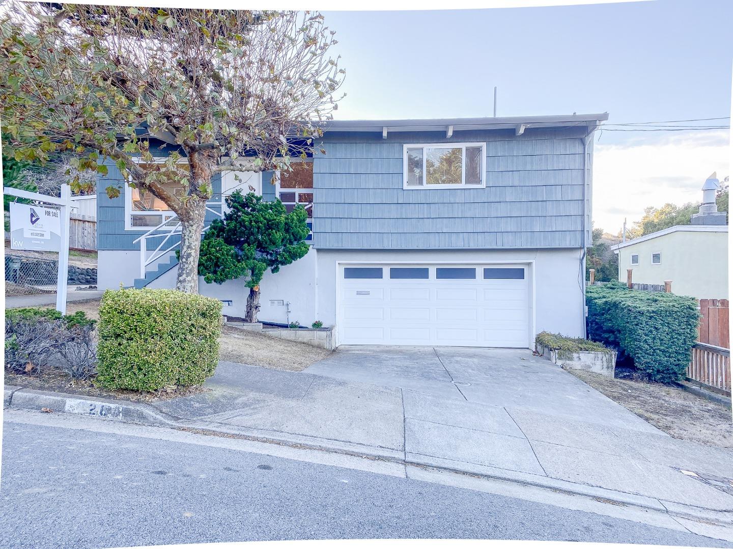 266 Hillside Drive Pacifica, CA 94044 - Photo 3 of 37 a front view of a house with a yard and garage