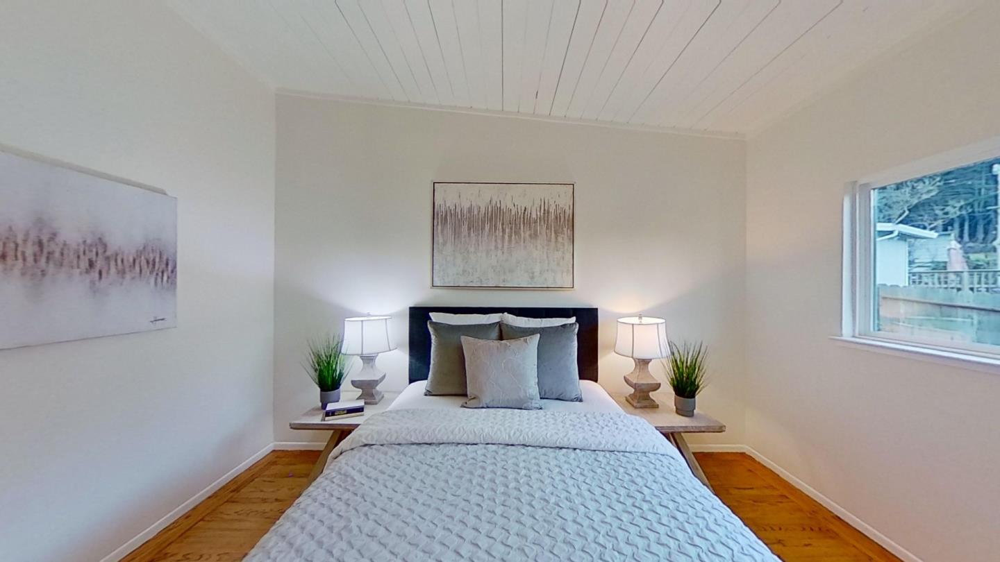 266 Hillside Drive Pacifica, CA 94044 - Photo 32 of 37 a bedroom with a bed and wooden floor