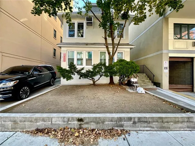 a view of a car park in front of a house