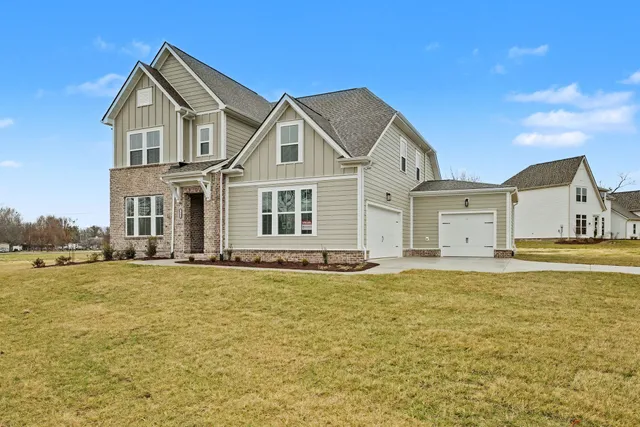 a house that has a large pool in front of it