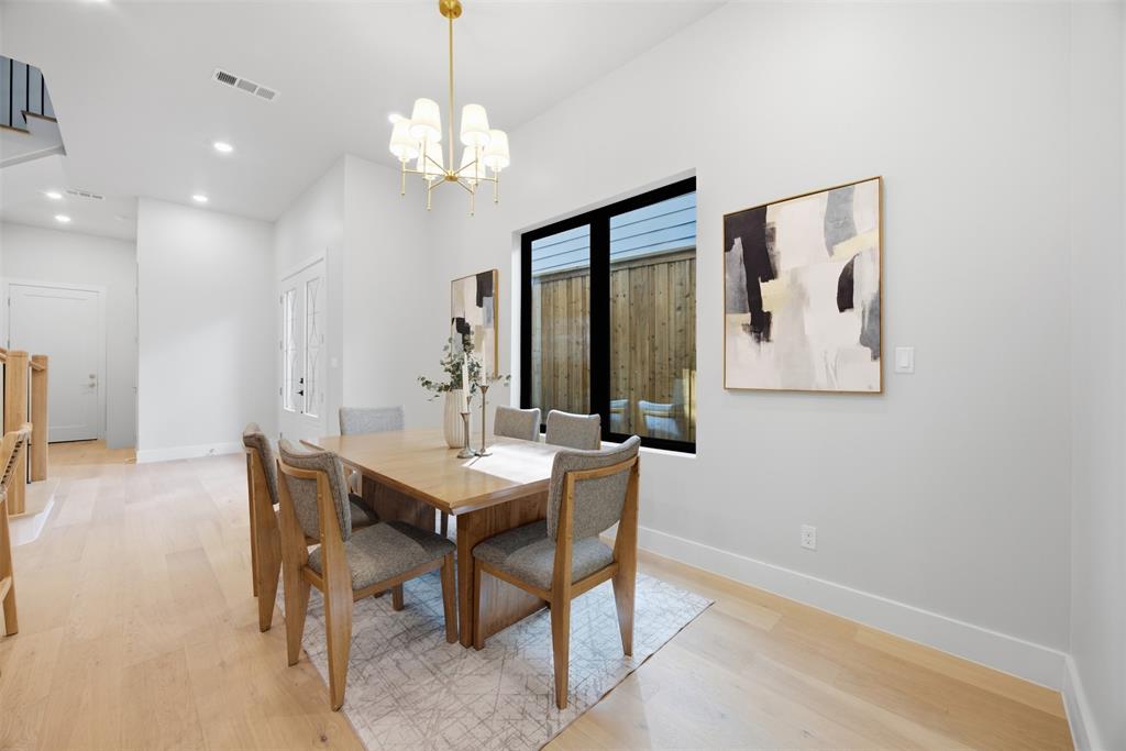 4615 Rusk Avenue Dallas, TX 75204 - Photo 22 of 40 a view of a dining room with furniture and a chandelier