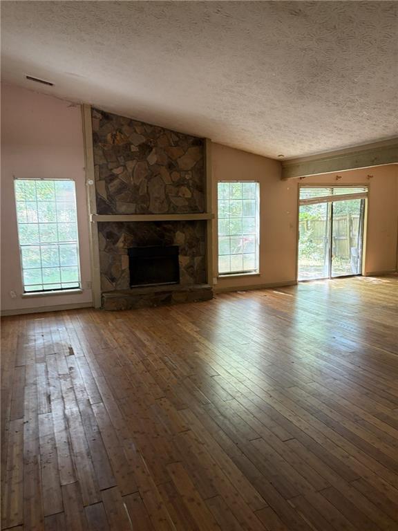 8521 Cedar Creek Ridge Riverdale, GA 30274 - Photo 2 of 9 an empty room with wooden floor fireplace and windows